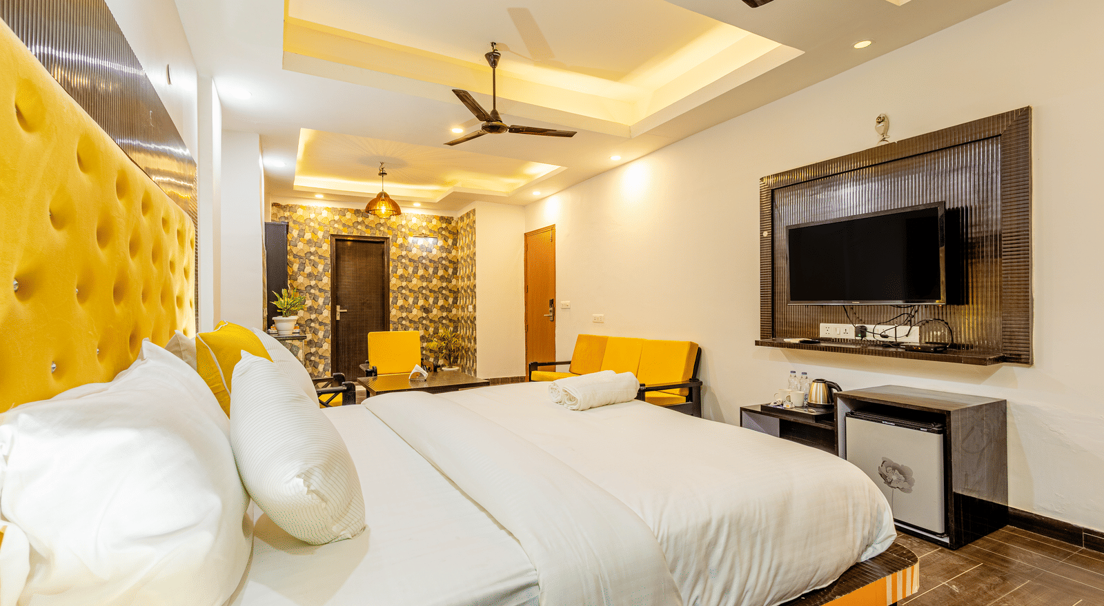 Side view of the king size bed in the suite at Lime Tree Hotels and Banquet Hall Near Huda Metro, Gurgaon