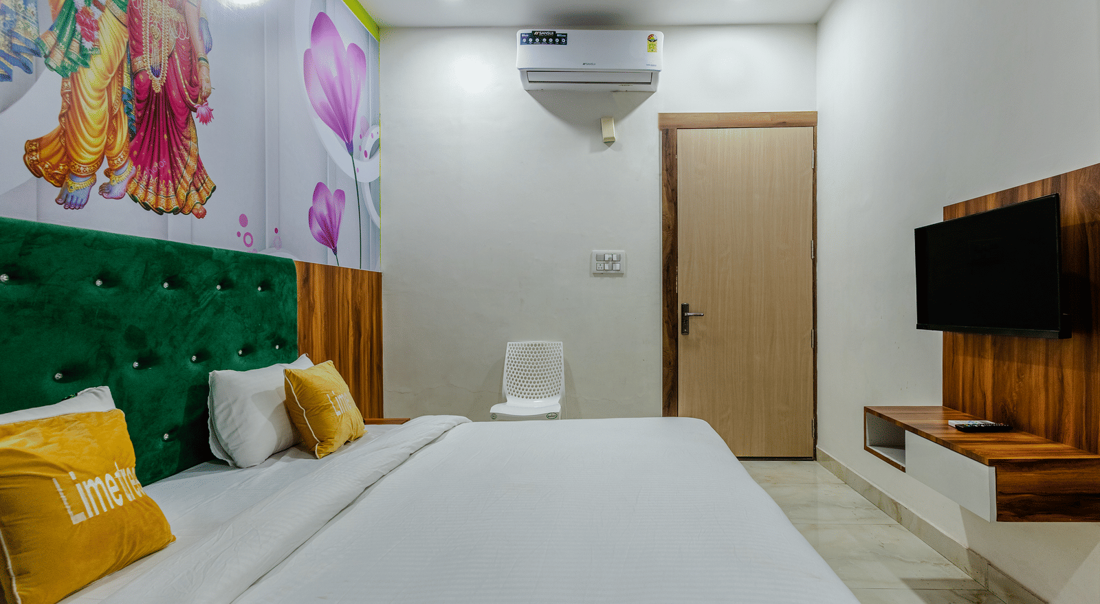 A close-up of a bedroom with green headboard, yellow cushions, and a wall-mounted air conditioner - Lime Tree Hotels & Banquet, Vrindavan