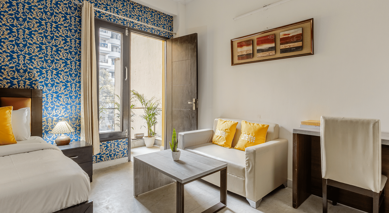 Room view with sofa and entry to balcony at Lime Tree
