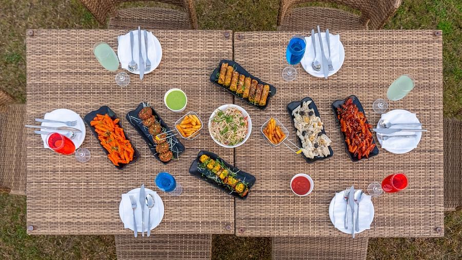 Outdoor dining setup with neatly arranged food and cutlery at DLS Park Grace, Haridwar.