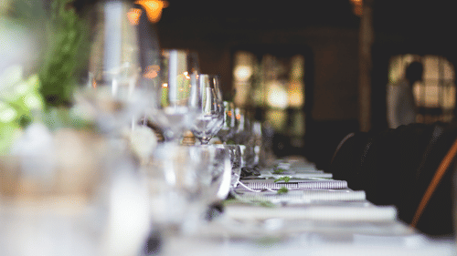 Glasses and plates arranged in a meeting hall during an event 