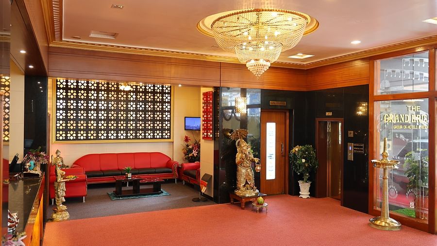 full view image of the lobby at The Grand Krishna Rooms featuring a common seating area and the entrance