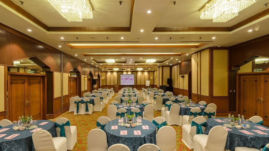 Banquet hall setup with blue tablecloths at  The Orchid Hotel Mumbai Vile Parle