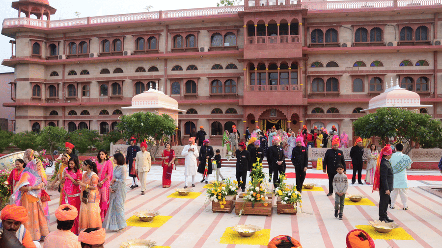 Grand wedding ceremony in a palace courtyard with traditional decor.