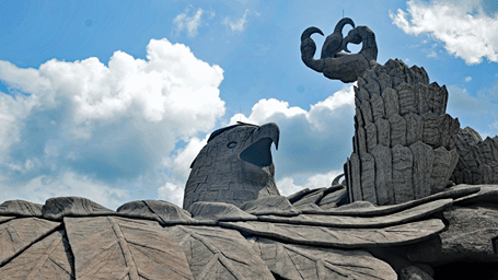 Eagle carved into the rock face, lying in the grotto