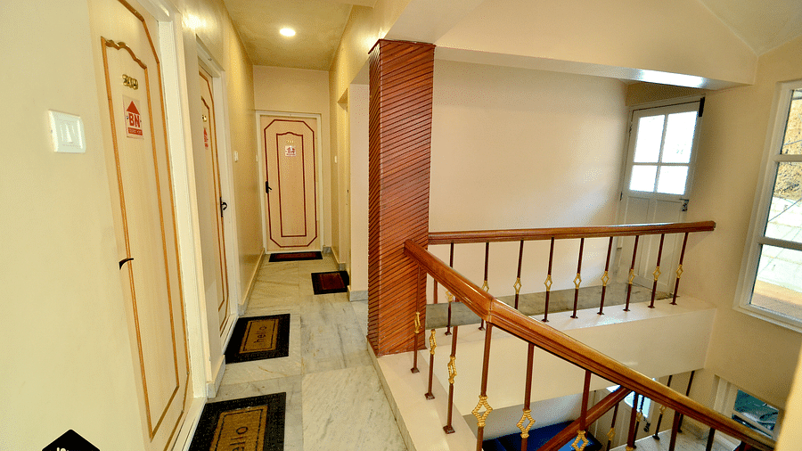 A hotel hallway with doors leading to guest rooms - BN Tourist Home, Ooty