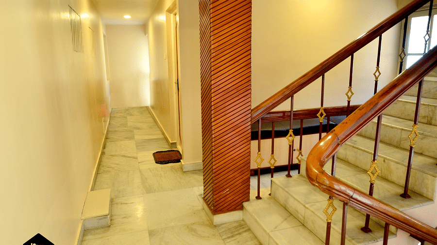 A well-lit hotel hallway with multiple doors leading to guest rooms - BN Tourist Home, Ooty