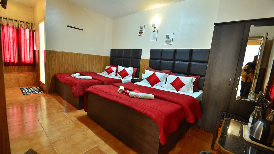 Image of a room with two beds and a wardrobe in the corner at BN Tourist Home.