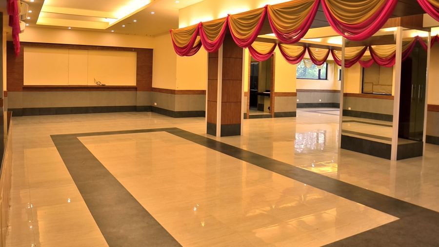 an expansive banquet hall well lit with warm lighting - Max Hotel, Jabalpur