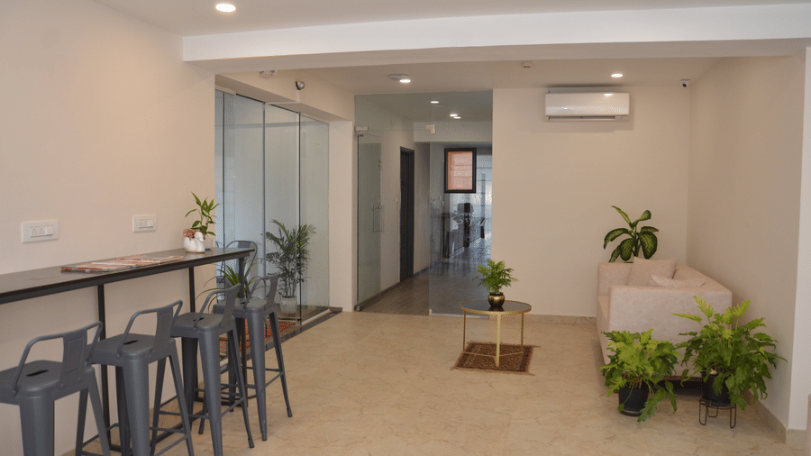 Corner view of the lobby featuring with modern interiors featuring a couch and a corridor in the corner - Lords Eco Inn Belagavi