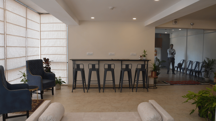 The lobby overlooking the common seating area facing the wall - Lords Eco Inn Belagavi