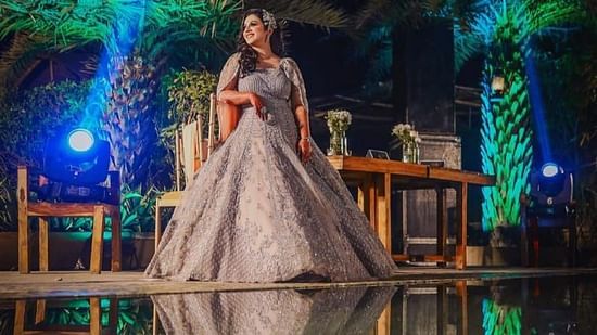 a woman in her wedding gown posing in nighttime at Themis Mudhouse Resorts