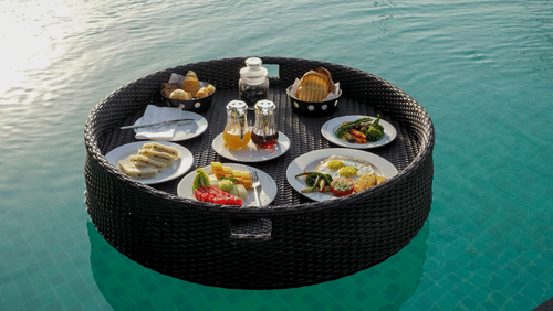 A floating breakfast tray kept on the swimming pool - Karma Lakelands.
