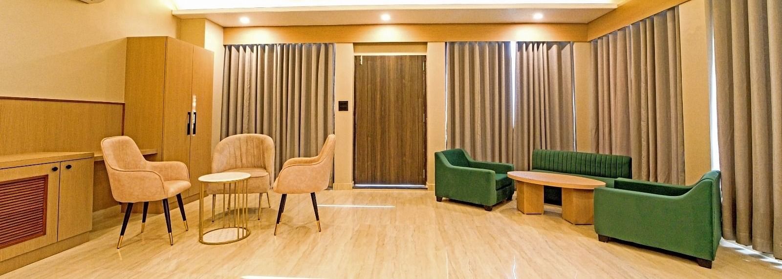 Spacious area at Grassfield Riveria Resort, Jaipur, with comfortable seating, large windows, and ambient lighting.