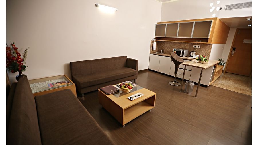 the living space with a sofa set and centre table at Deluxe suites in Vizag