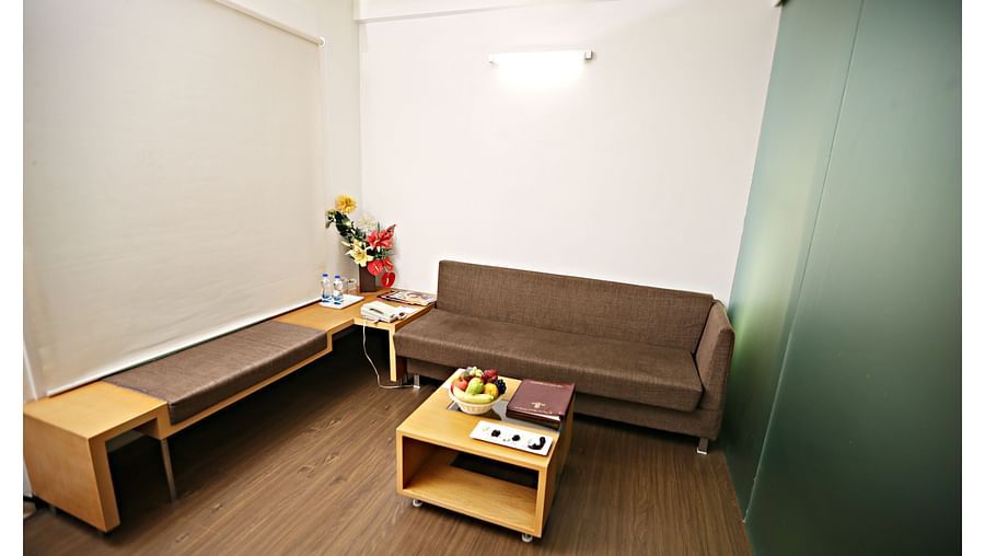 the living space with a sofa set and centre table at Deluxe suites in Vizag 1
