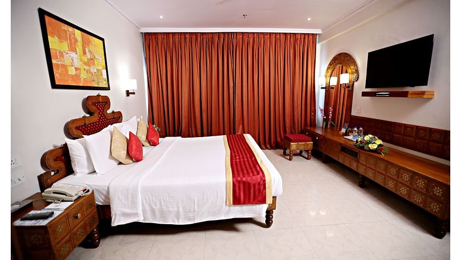 the king size bed offered at Deluxe Rooms in Vizag 3