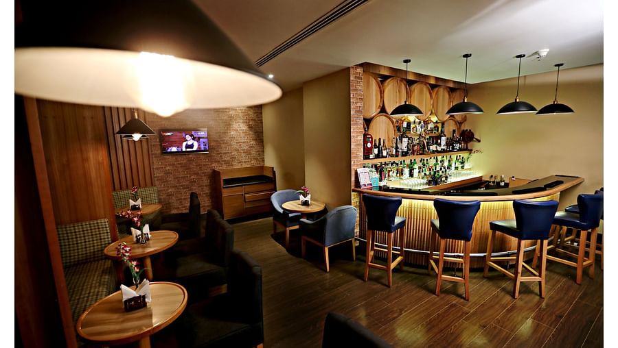 the seating area opposite to the bar counter at Woodhouse bar in Vizag