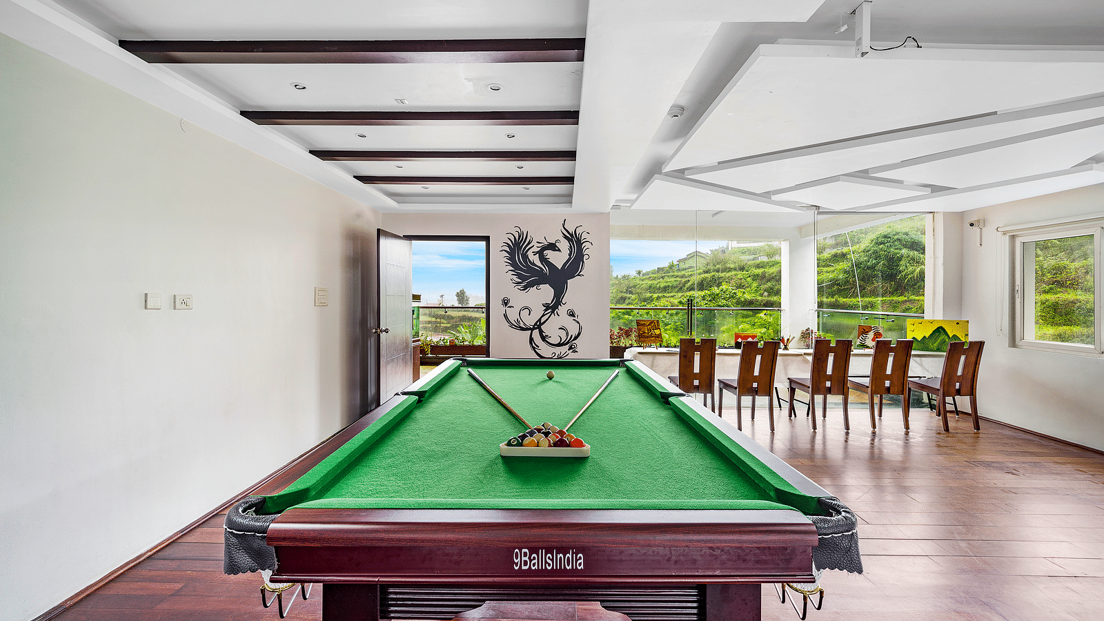 An image of pool table in the indoor games area which also has chairs - GReaT Trails Kodaikanal By GRT Hotels