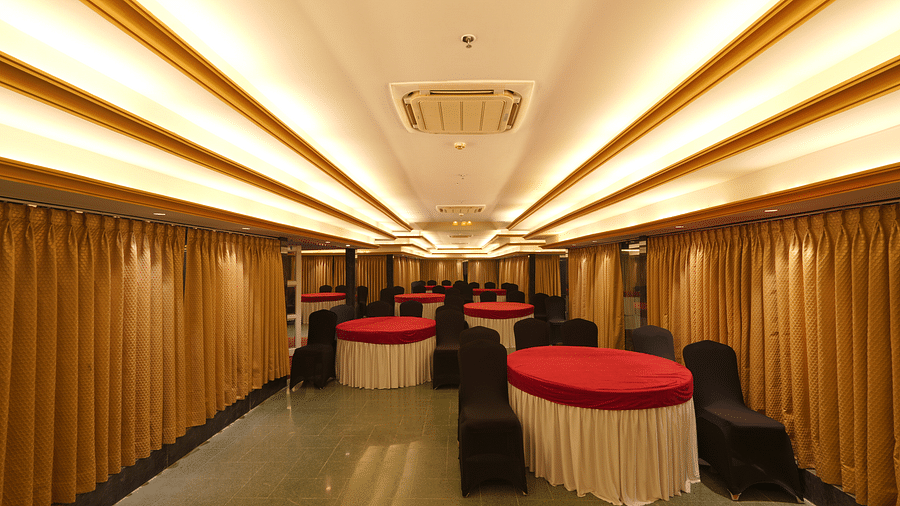 Chairs and round tables at Moti Mahal, our in-house banquet hall at The Garden Ananta Elite, Rajkot 3
