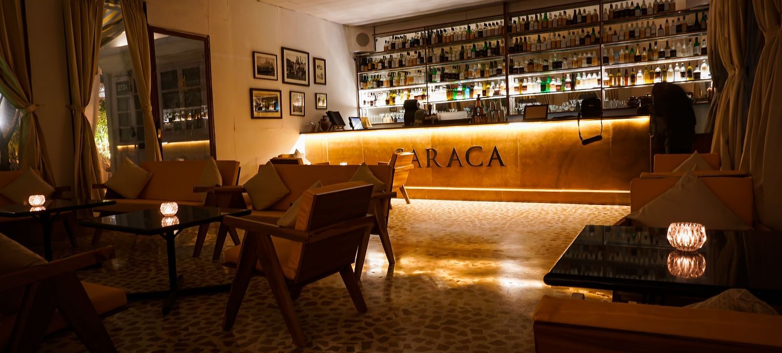 Interiors of Saraca Bar at Saraca Hotel, Lucknow with a wooden theme and a moody ambience with spot lighting