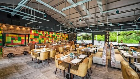 An image of a restaurant with seating arrangement and valley views - GReaT Trails Kodaikanal By GRT Hotels