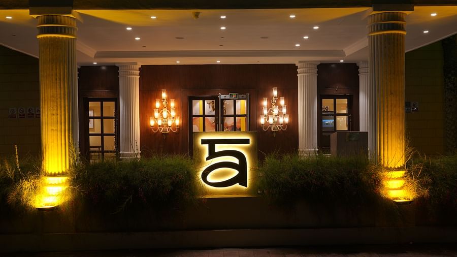 Night view of the Image of a huge A, the logo of Ananta in front of the facade of  The Garden Ananta Elite, Rajkot