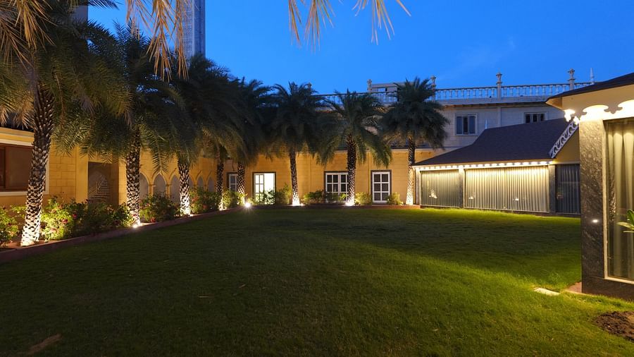 Front view of the green grass and tress at night at Rajbageecha, our in-house garden banquet at The Garden Ananta Elite, Rajkot 6