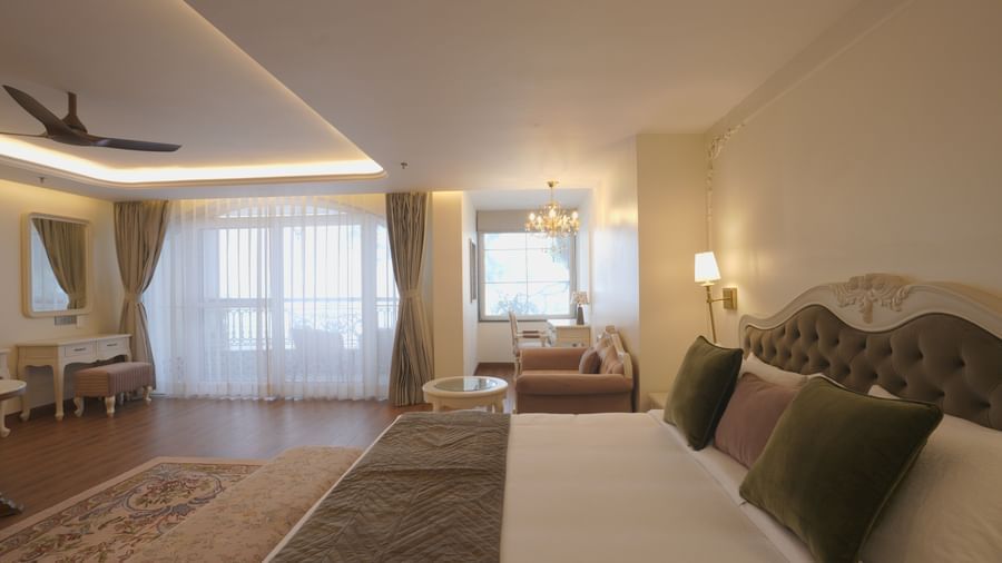 Premium bedroom featuring a plush bed, large windows, and subtle decor - Mayfair Cafe & Suites, Dalhousie
