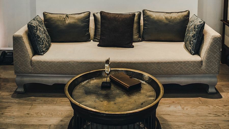 An elegant beige coloured couch with a coffee table - two bedroom private pool beachfront villa
