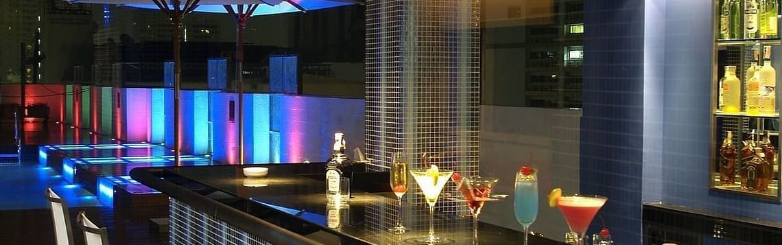 An overview of the bar counter inside Flava Lite Rooftop Pool Bar Cafe - Night Hotel Bangkok.