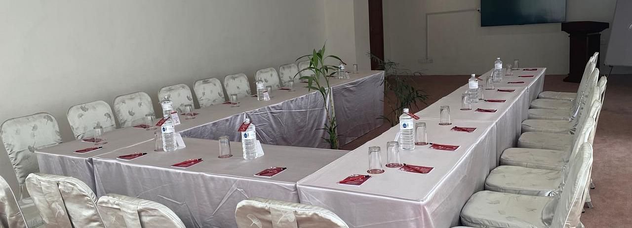 A banquet hall, windows with curtains and TV