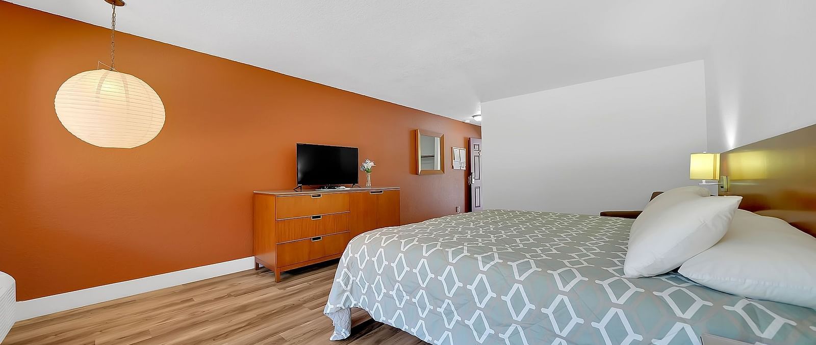 A view of a room at Amador Hotel with a double bed and a television.