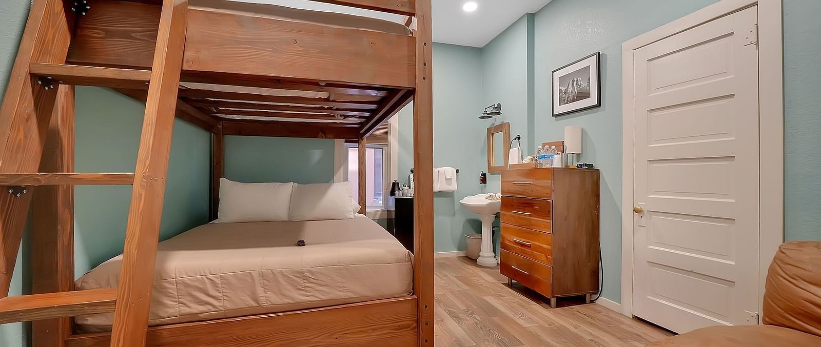 A view of a room at The Groveland Hotel with bunk beds.