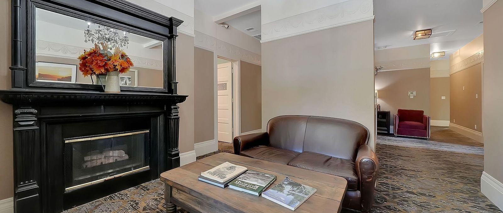 Living room area of a suite at The Groveland Hotel with sofa seating and a coffee table.