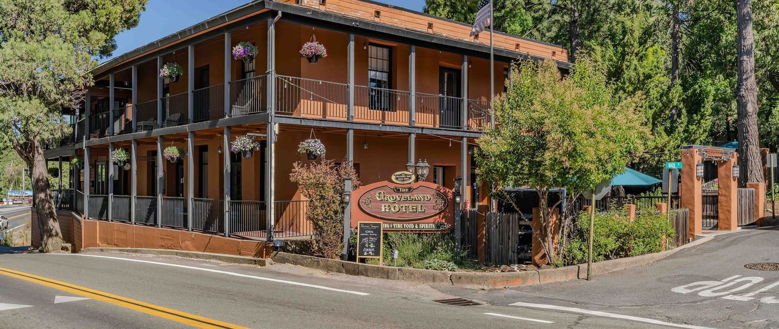 Exterior of a cabin at The Groveland Hotel during the day with the hotel's signage in view.