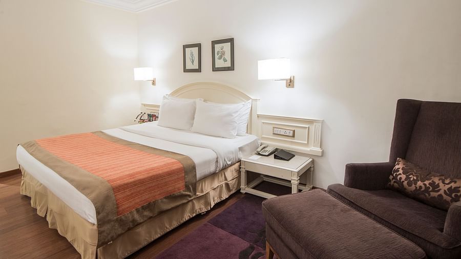room with king size bed and wooden flooring at hotel bawa international