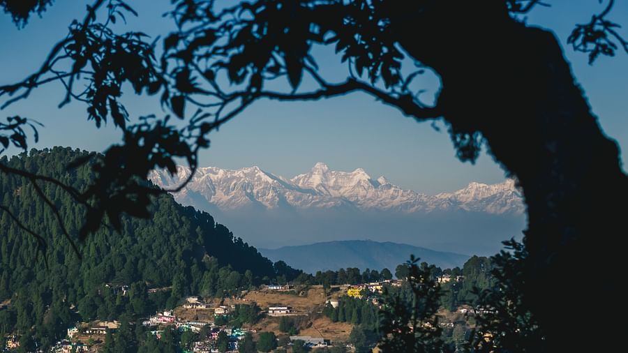 A top-angle shot from a mountain view, offering a panoramic view of the entire city below.