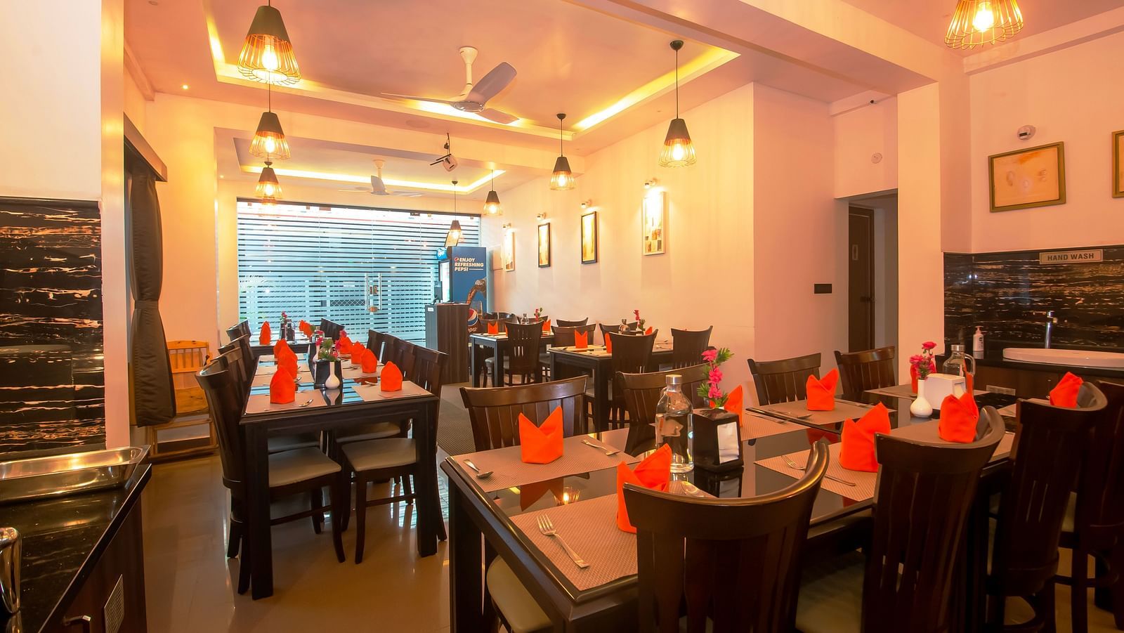 Image of a dining area with napkins arranged on the table at Hotel Altitude, Madikeri.