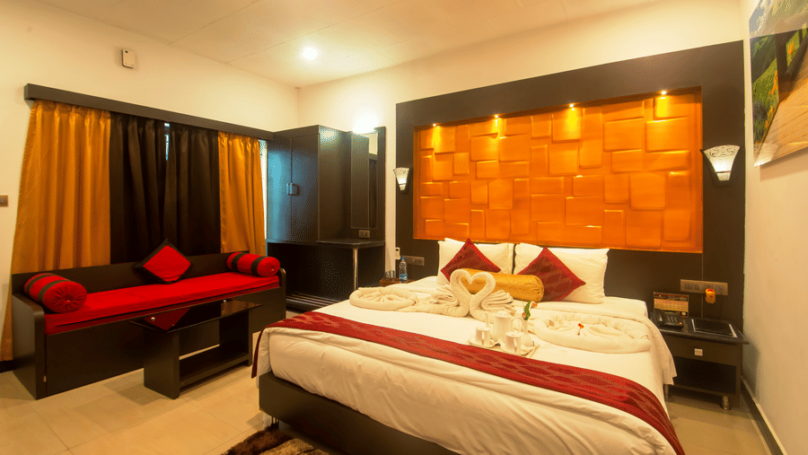 Image of a room with a bed and a sofa on the side at Coorg Jungle Camp Backwater Resort, Kushalnagar.