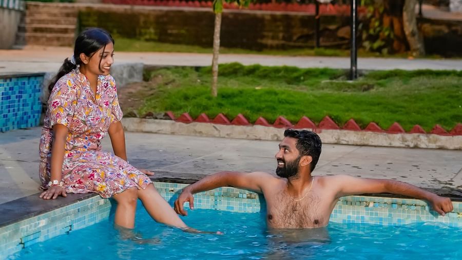 A man and woman relaxing in an outdoor swimming pool at WOW Bungalow, Yercaud.