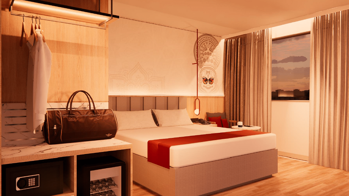 A close up shot of the plush bed in a room with warm lighting at TGI Oberon, Koramangala