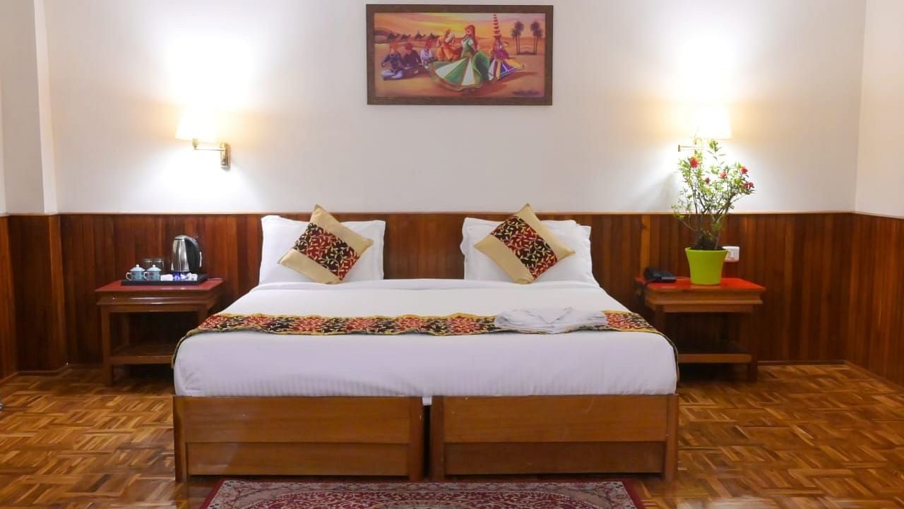 An image of a room featuring a bed, bed side table, wall hangings and rug - Sumitel Chiminda, Pelling