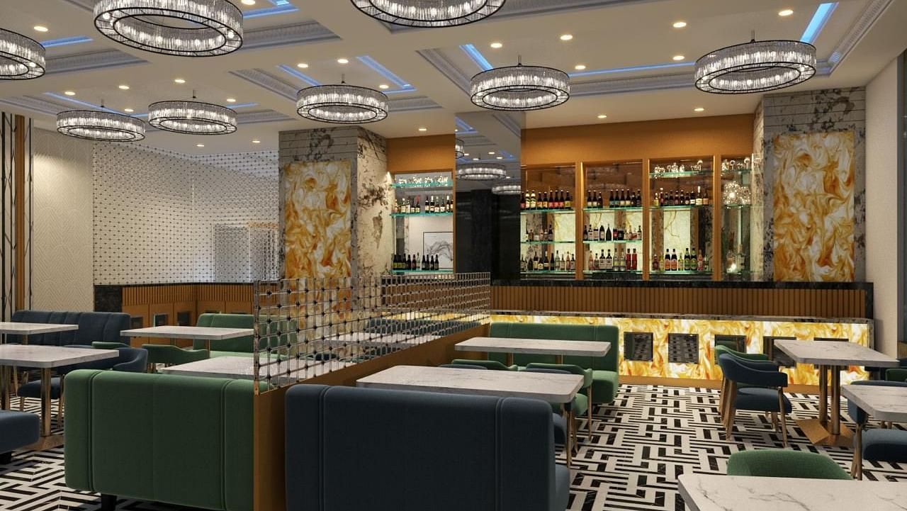 Dining space with a patterned carpet, featuring chairs and tables arranged on it at Hotel Mumbai House, Vashi.