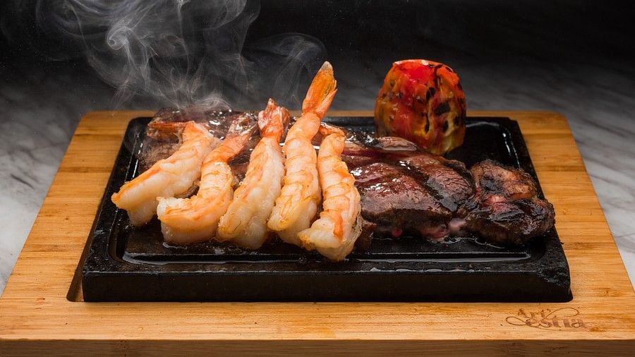 An image of a steaming hot dish made of prawns and steak - S Hotel Montego Bay, Jamaica