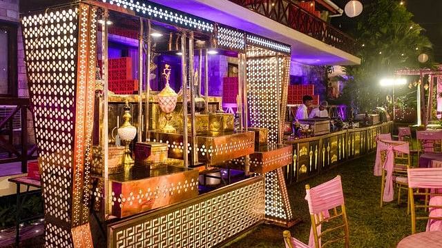 alt-text Festive bar area with colorful lights and decorations.