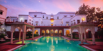 An image of Amritara Chandra Mahal building with multiple storeys and in front there is also a swimming pool