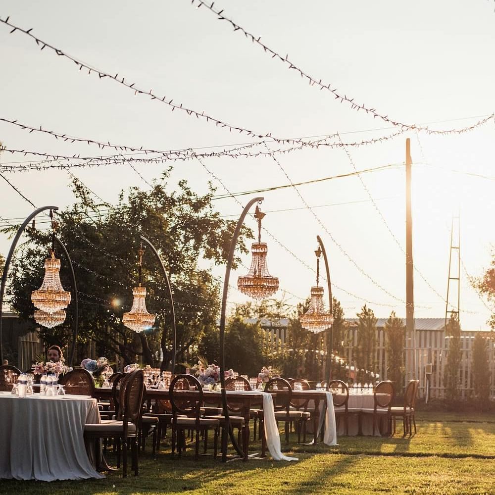 Image of an event space with tables and chairs and lights hanging above.