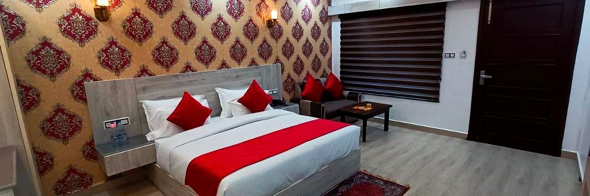 A Premium Room at DLS Nature Trinket Resort  with a king size bed and side tables.