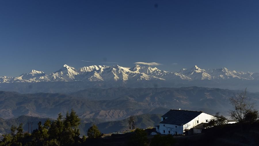 A stunning view of snow-clad peaks from a cosy hillside building - BluSalzz Escapade - Anant Rasa Resort